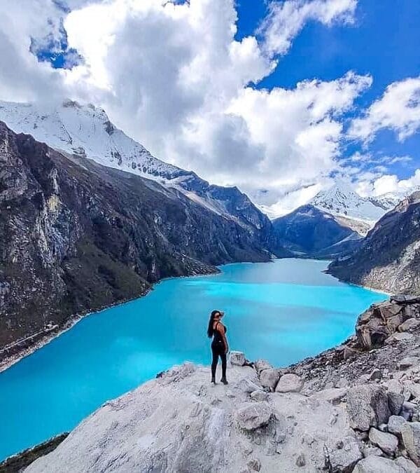 Turquoise Laguna Parón glacial lake surrounded by snowy mountains