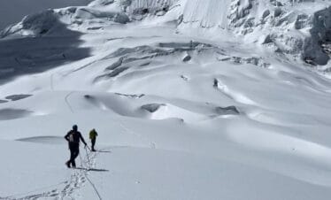Climbers approaching Tocllaraju high camp at sunrise