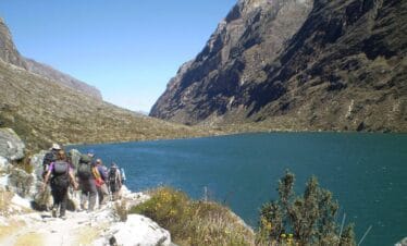 Hikers on Santa Cruz Trekking Tours Peru walking through high Andean valleys near Alpamayo