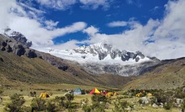 Camping at Taullipampa during Santa Cruz Trekking Tours Peru surrounded by snow-capped peaks