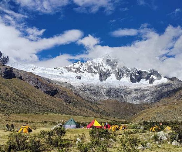 Camping at Taullipampa during Santa Cruz Trekking Tours Peru surrounded by snow-capped peaks