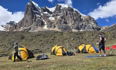 Camp site along the Huayhuash Trek Classic surrounded by dramatic Andean mountains
