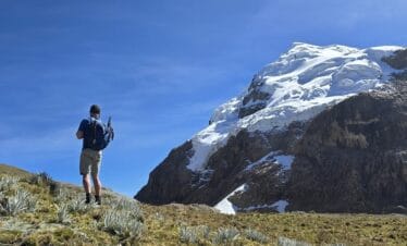 Huayhuash Trek Classic crossing a high mountain pass with Yerupajá peak in the background