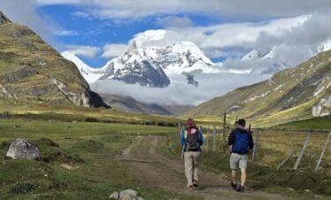 Short Huayhuash Trek crossing a high mountain pass with snow capped peaks