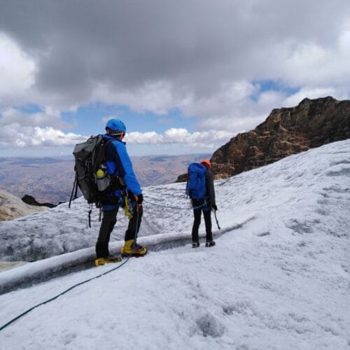 Climb Vallunaraju from Huaraz with mountaineers crossing glacier terrain